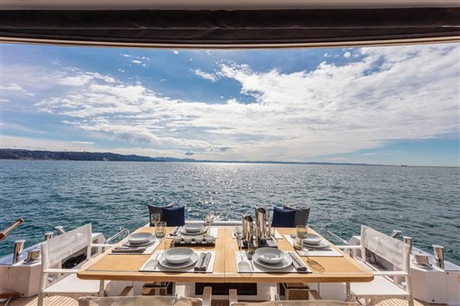 Luxurious dining setup on Pardo Yachts Endurance 60, 2025, overlooking serene ocean view.