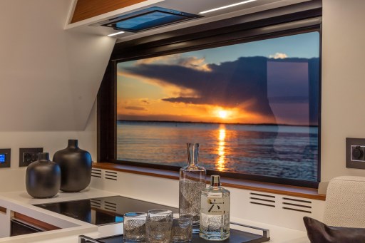 Luxurious interior of 2025 Pardo Yachts Endurance 60 with sunset view through window.