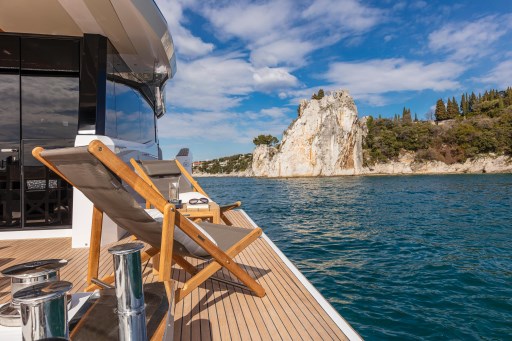Luxury Pardo Yachts Endurance 60 on serene waters, 2025 model, with scenic coastal view.