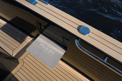 2026 Pardo Yachts 43 deck detail with logo, featuring sleek wood finish and chrome accents.