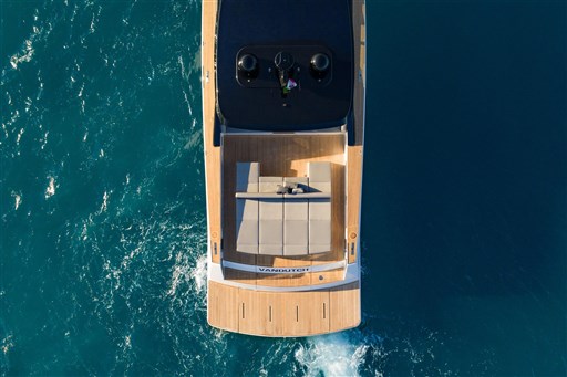 Aerial view of 2025 VanDutch 75 yacht cruising on blue ocean waters.