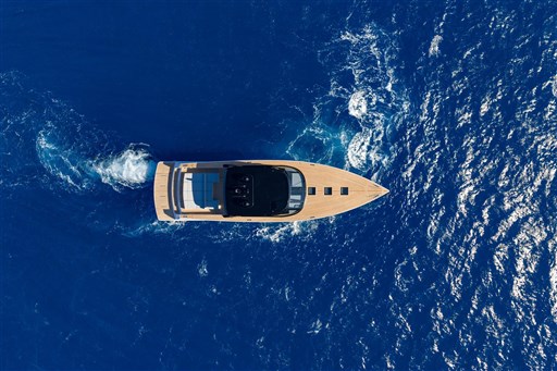 Aerial view of 2025 VanDutch 75 yacht cruising on deep blue ocean waters.