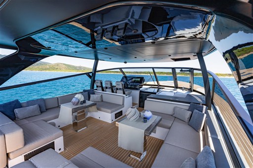 Luxurious 2025 VanDutch 75 yacht interior with elegant seating and scenic ocean view.