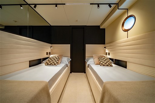 Luxurious twin cabin interior of 2025 VanDutch 75 yacht, featuring modern design and ambient lighting.