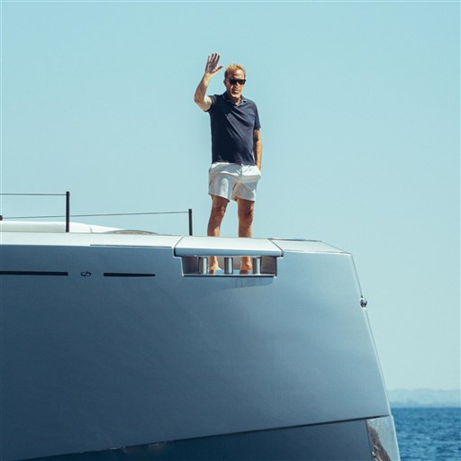 Man waving on Pardo Yachts GT75, 2025 model, under clear blue sky.