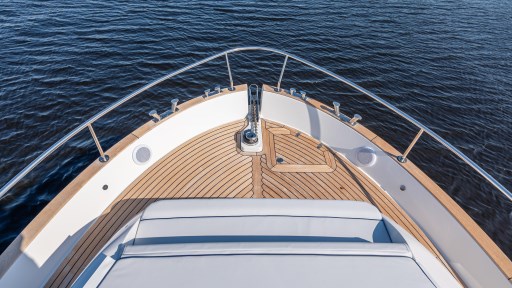 2024 Apreamare GOZZO 38 CABIN yacht bow with teak deck on calm water.