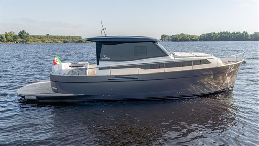 2024 Apreamare GOZZO 38 CABIN yacht on calm water, side view.