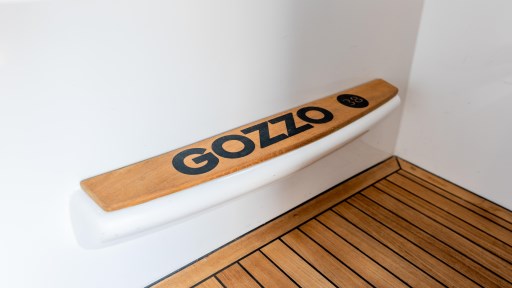 2024 Apreamare Gozzo 38 Cabin interior detail with wooden flooring and branded step.