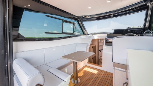 2024 Apreamare GOZZO 38 CABIN interior with white seating and wooden flooring.