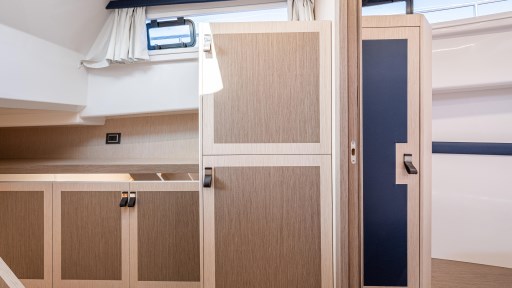 Interior of 2024 Apreamare GOZZO 38 CABIN with modern wood cabinetry and window.