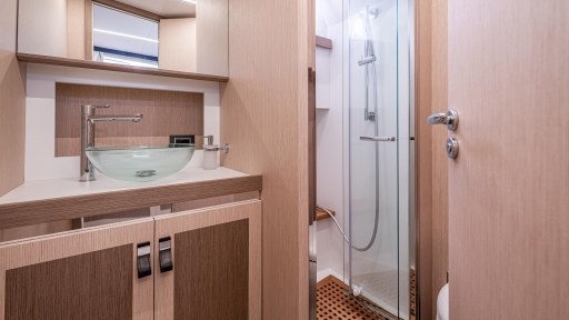 Luxurious bathroom in 2024 Apreamare GOZZO 38 CABIN yacht with modern fixtures and glass shower.