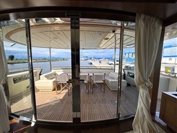 Luxurious 2008 Riva 115 Athena yacht interior with elegant deck seating and waterfront view.