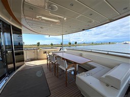 Luxurious 2008 Riva 115 Athena yacht deck with seating and scenic water view.