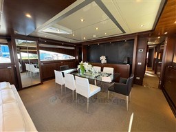 Luxurious dining area on 2008 Riva 115 Athena yacht with elegant decor and modern furnishings.
