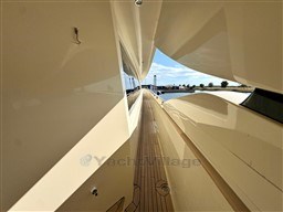 Side deck view of 2008 Riva 115 Athena yacht, showcasing sleek design and wooden flooring.