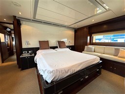 Luxurious bedroom interior of 2008 Riva 115 Athena yacht with modern design and cozy ambiance.