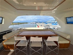 Luxurious 2008 Riva 115 Athena yacht deck with seating and scenic marina view.