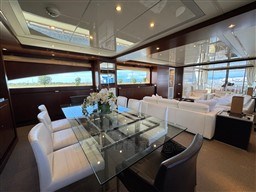 Luxurious interior of 2008 Riva 115 Athena yacht with elegant dining and seating area.