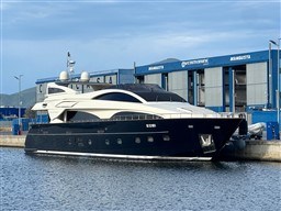 Luxury 2008 Riva 115 Athena yacht docked at shipyard, clear sky background.