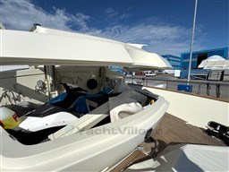 2008 Riva 115 Athena yacht with open storage compartment, revealing a jet ski and equipment.