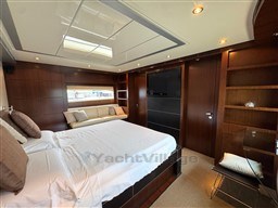 Luxurious bedroom interior on 2008 Riva 115 Athena yacht with modern furnishings and elegant wood paneling.