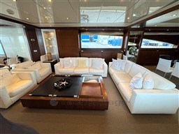 Luxurious interior of 2008 Riva 115 Athena yacht with elegant white sofas and modern decor.