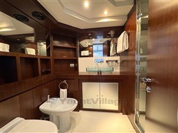 Luxurious bathroom on 2008 Riva 115 Athena yacht with wood accents and modern fixtures.