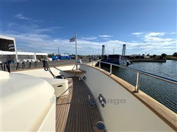 2008 Riva 115 Athena yacht deck with marina view under clear blue sky.