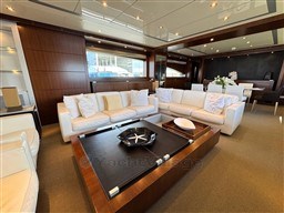 Luxurious interior of 2008 Riva 115 Athena yacht with elegant white sofas and wooden accents.