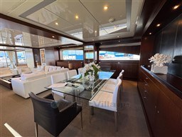 Luxurious interior of 2008 Riva 115 Athena yacht with elegant dining area and modern decor.