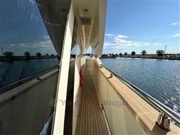 Side view of 2008 Riva 115 Athena yacht on calm water under clear sky.