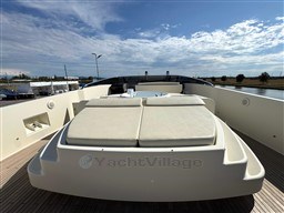 Luxurious 2008 Riva 115 Athena yacht deck with sunbathing area under a clear sky.