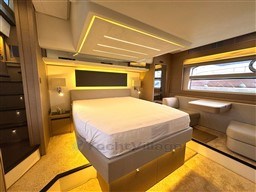 Luxurious interior of 2019 Prestige 590 yacht with modern bedroom design and ambient lighting.