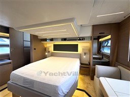 Luxurious interior of a 2019 Prestige 590 yacht bedroom with modern design and ambient lighting.