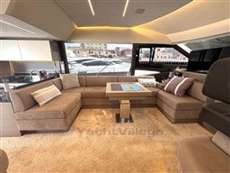 Luxurious interior of a 2019 Prestige 590 yacht with plush seating and modern design.