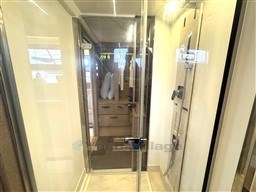 Luxurious bathroom interior of 2019 Prestige 590 yacht with glass shower enclosure.