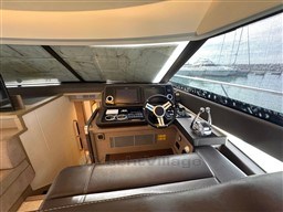 Luxurious interior of a 2019 Prestige 590 yacht helm station with modern controls.