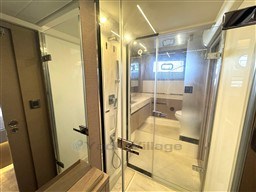 Luxurious bathroom interior of 2019 Prestige 590 yacht with glass shower enclosure.