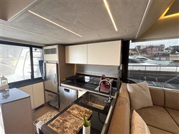 Luxurious 2019 Prestige 590 yacht kitchen with modern appliances and elegant design.