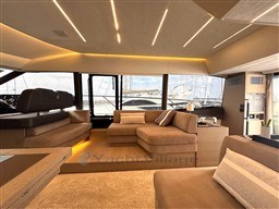 Luxurious interior of a 2019 Prestige 590 yacht with modern seating and ambient lighting.
