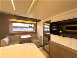 Luxurious interior of a 2019 Prestige 590 yacht with modern seating and TV.