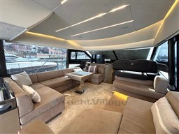 Luxurious interior of 2019 Prestige 590 yacht with modern seating and ambient lighting.