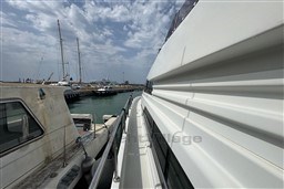 1989 Mochi Craft MOCHI 56 yacht docked in a marina under cloudy skies.