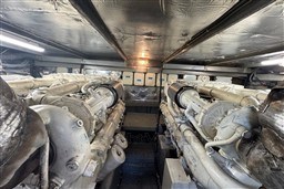 Engine room of 1989 Mochi Craft MOCHI 56 yacht, featuring dual engines and metallic insulation.