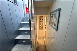 Interior of 1989 Mochi Craft MOCHI 56 yacht with carpeted stairs and framed artwork.