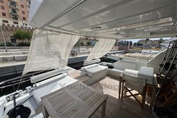 Spacious deck of 1989 Mochi Craft MOCHI 56 yacht with seating and wooden table.