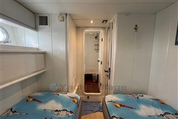 Cabin interior of 1989 Mochi Craft MOCHI 56 yacht with twin beds and nautical decor.