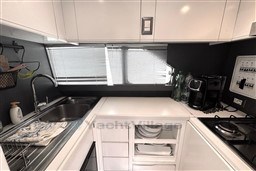 Compact kitchen in 1989 Mochi Craft MOCHI 56 yacht with modern appliances and sleek design.