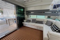 Luxurious interior of 1989 Mochi Craft MOCHI 56 yacht with white seating and wooden flooring.