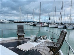 Deck view of 1996 Sanlorenzo 62 yacht in a marina with sailboats.